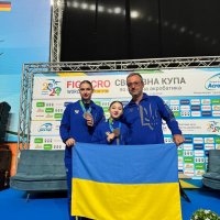 Спортсменки та тренер з прапором України